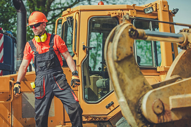 Man in construction outfit gets out of truck.