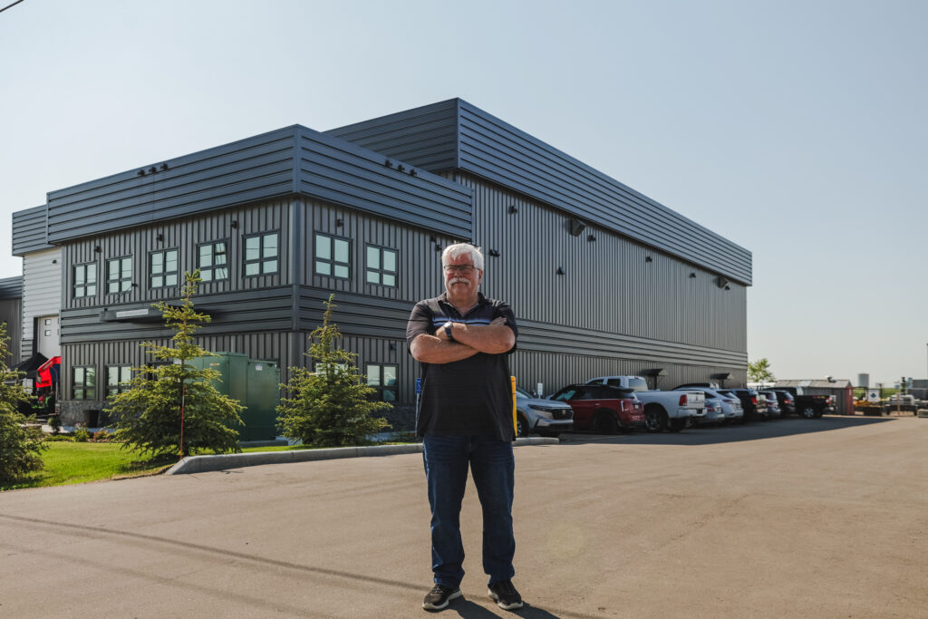 Man stands in front of commercial building.